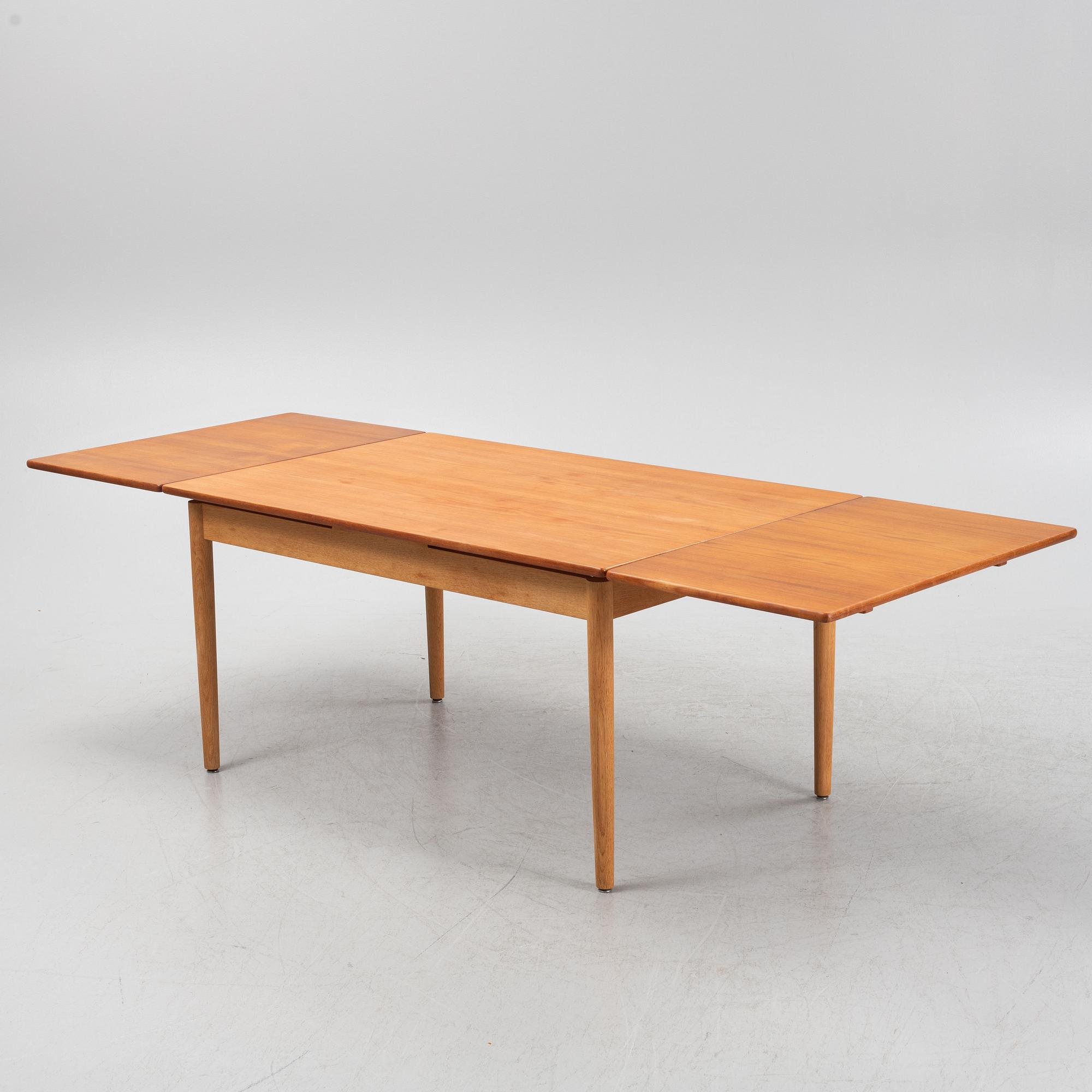 Hans J. Wegner, an oak and teak dinner table for Andreas Tuck. Denmark.