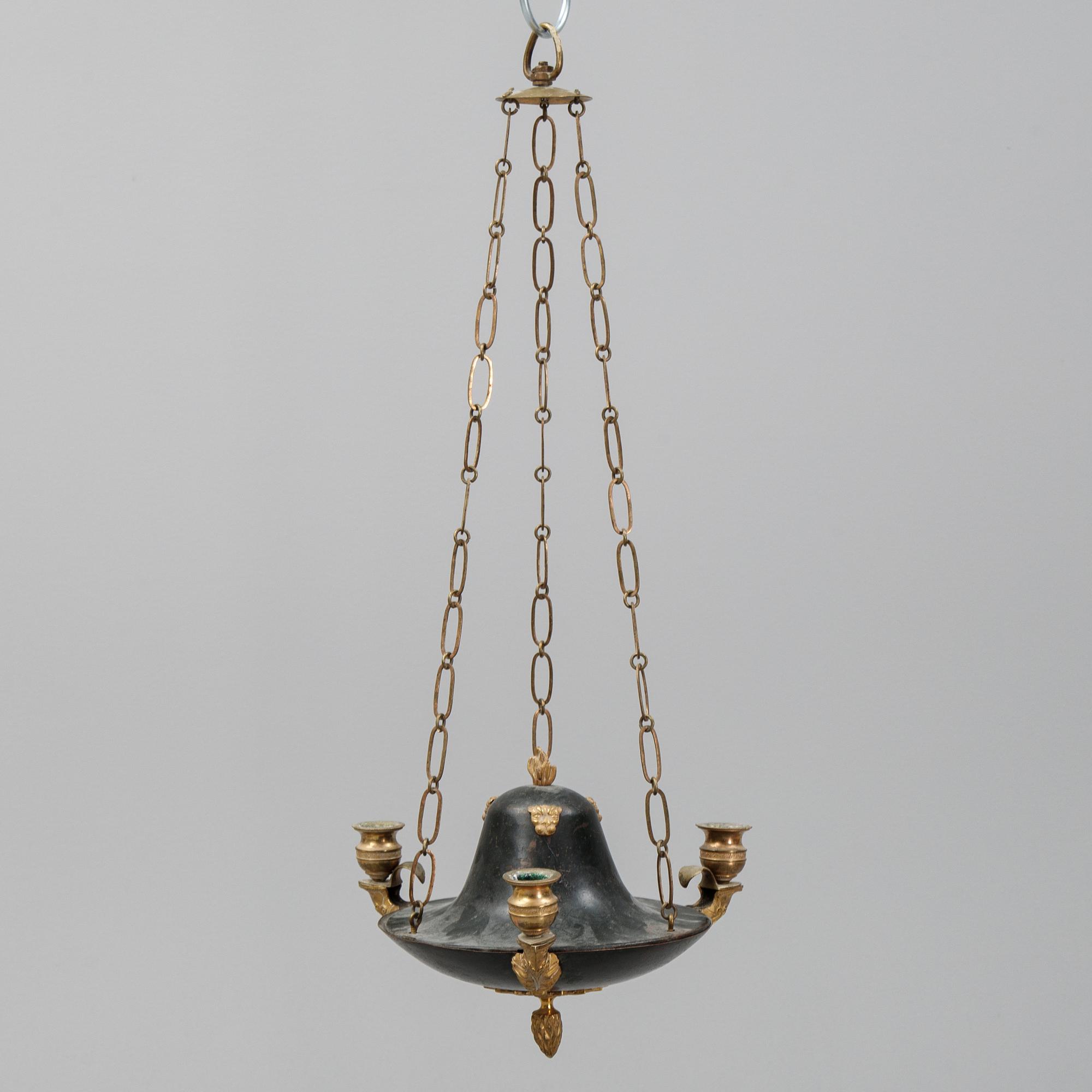 A Swedish Empire style 20th century three-light patinated brass hanging-lamp.