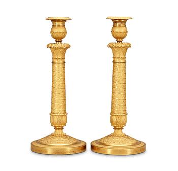 523. A pair of French Empire early 19th Century candlesticks.