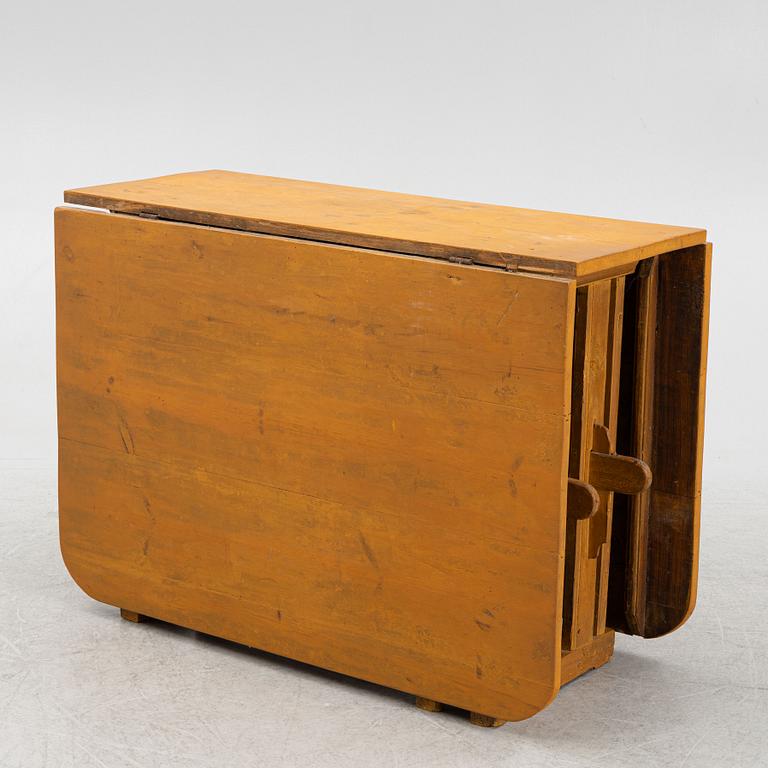 A drop-leaf table, circa 1900.