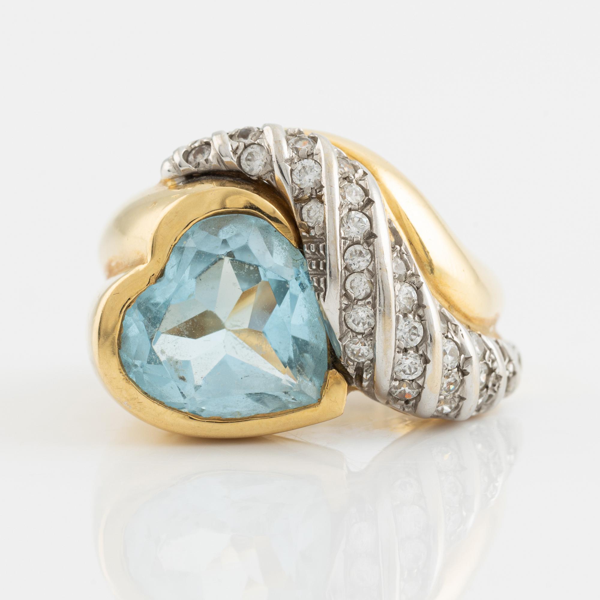 18K gold and heart shaped blue topaz and white stones.