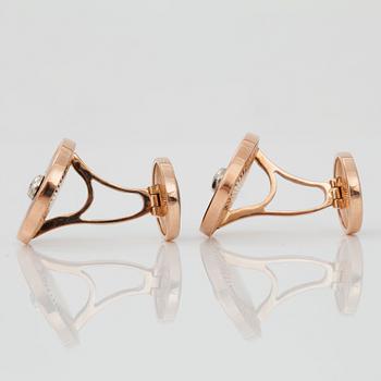 A pair of cufflinks, red enamel and brilliant cut diamond.