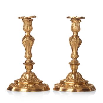 A pair of French Louis XV mid 18th century gilt bronze candlesticks.