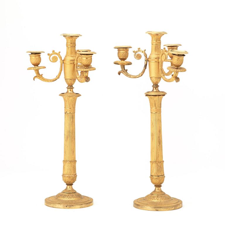 A pair of French Empire early 19th century gilt bronze four-light candelabra.