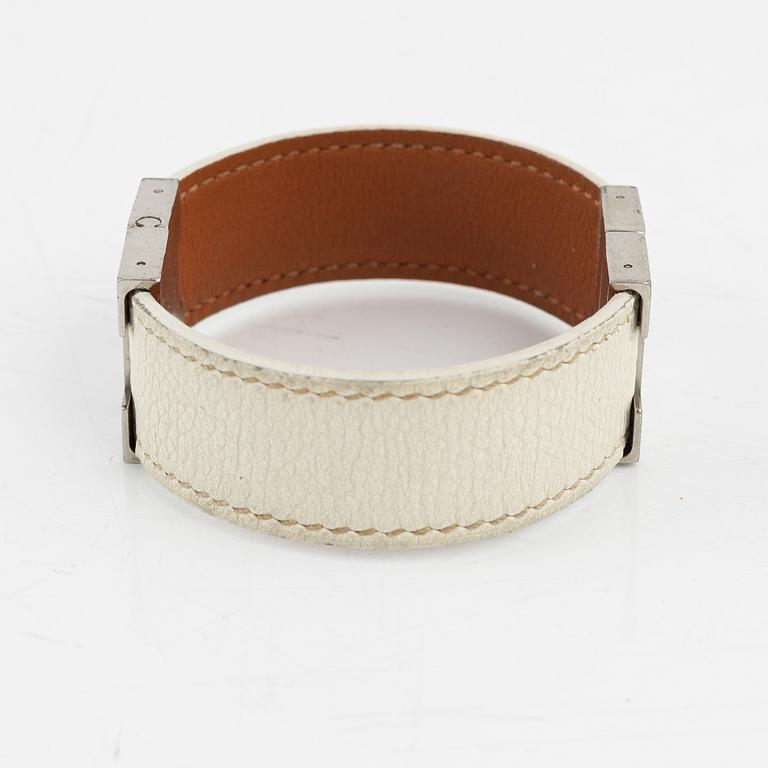 Hermès, a white leather bracelet.