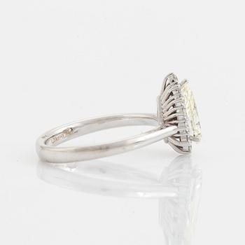 An 18K white gold ring set with  a pear brilliant-cut diamond.