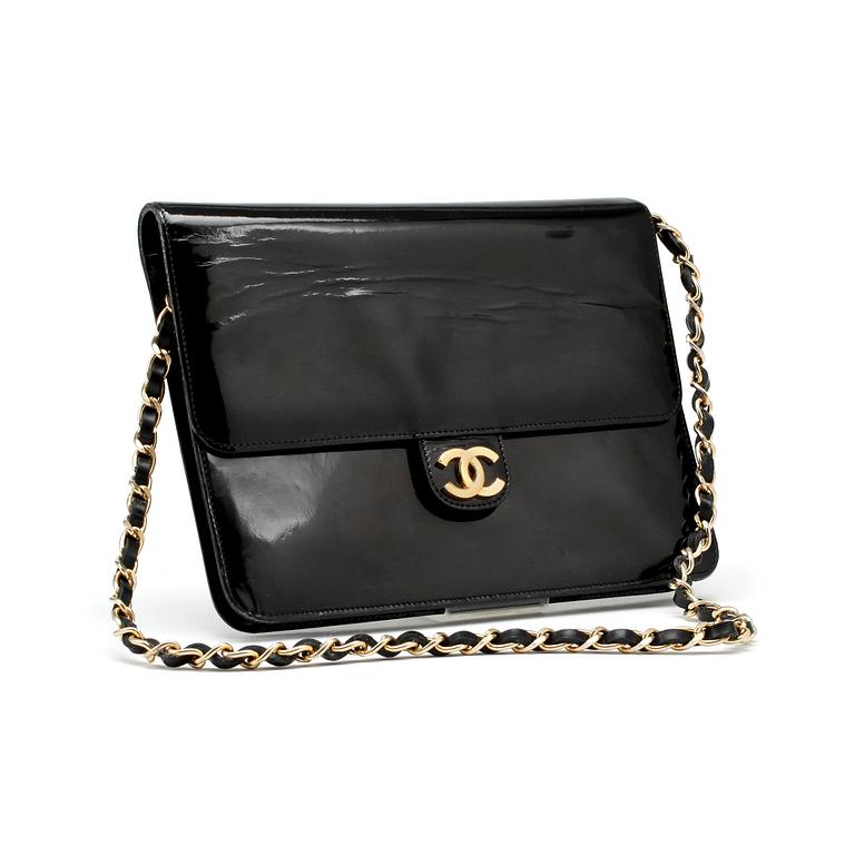 CHANEL, a black patent leather flap bag.
