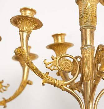 A pair of Napoleon III five-branch gilt and patinated bronze appliques.