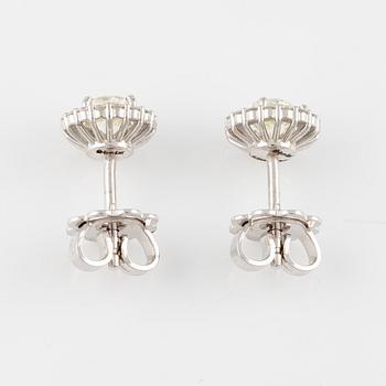 A pair of earrings in 18K white gold with round brilliant-cut diamonds.