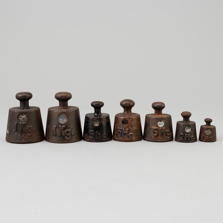 A 20th century cast iron balance with brass and iron weights, partly Skultuna, Sweden.