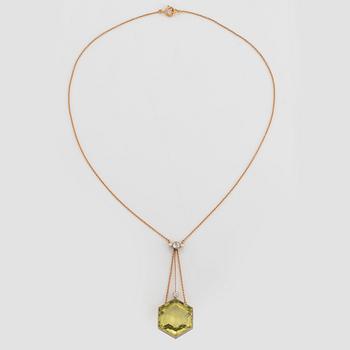 An 18K gold and platinum pendant set with a faceted beryl, old-cut diamonds and pearls.