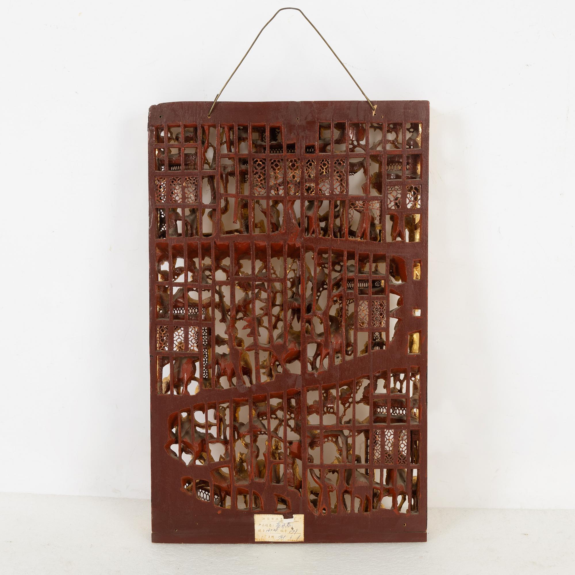 A carved Chinese wooden panel, late Qing dynasty, circa 1900.