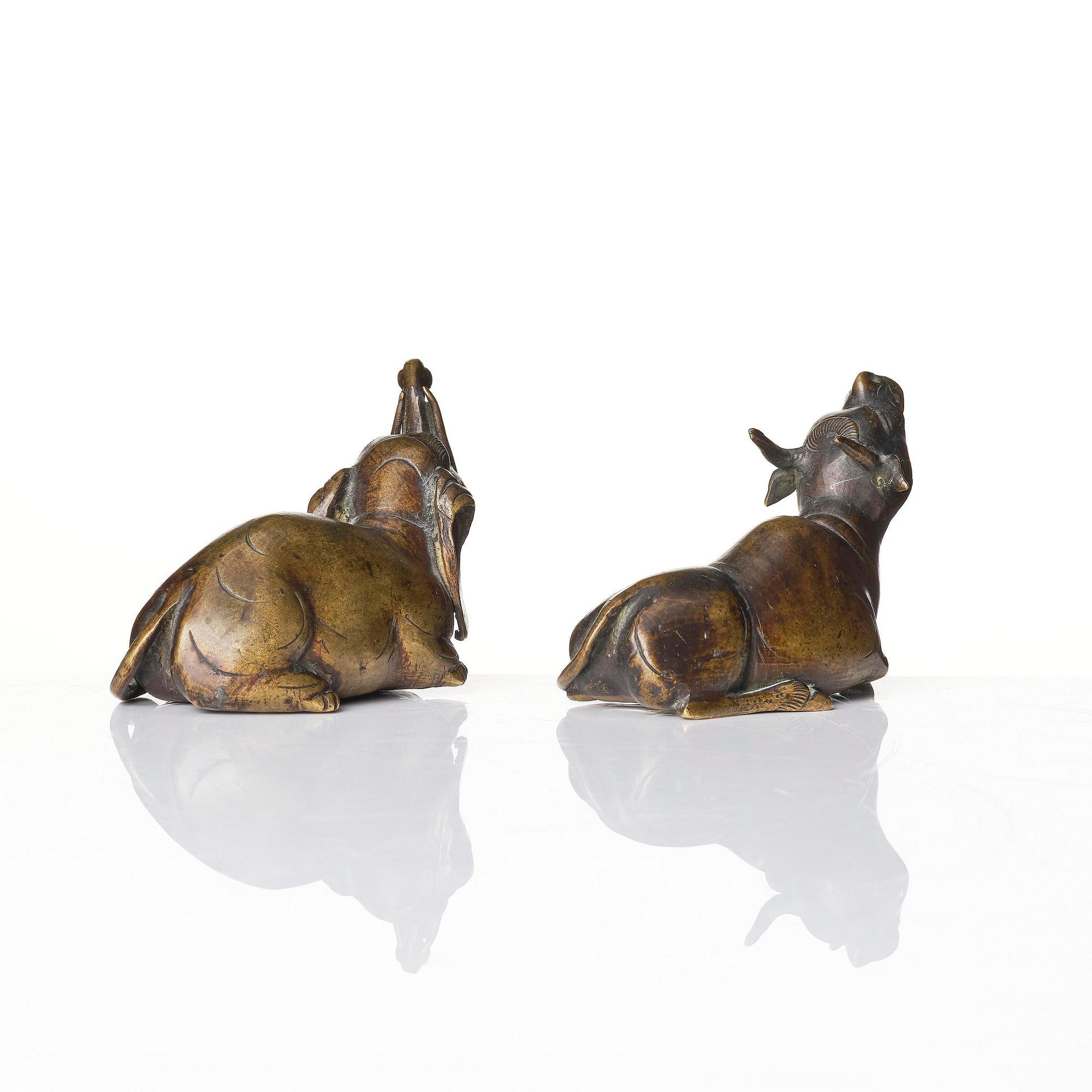 A set of two bronze scroll weights/sculptures, late Ming dynasty/early Qing dynasty.