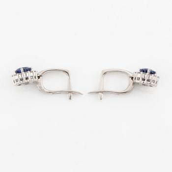 A pair of 14K gold earrings with faceted sapphires.
