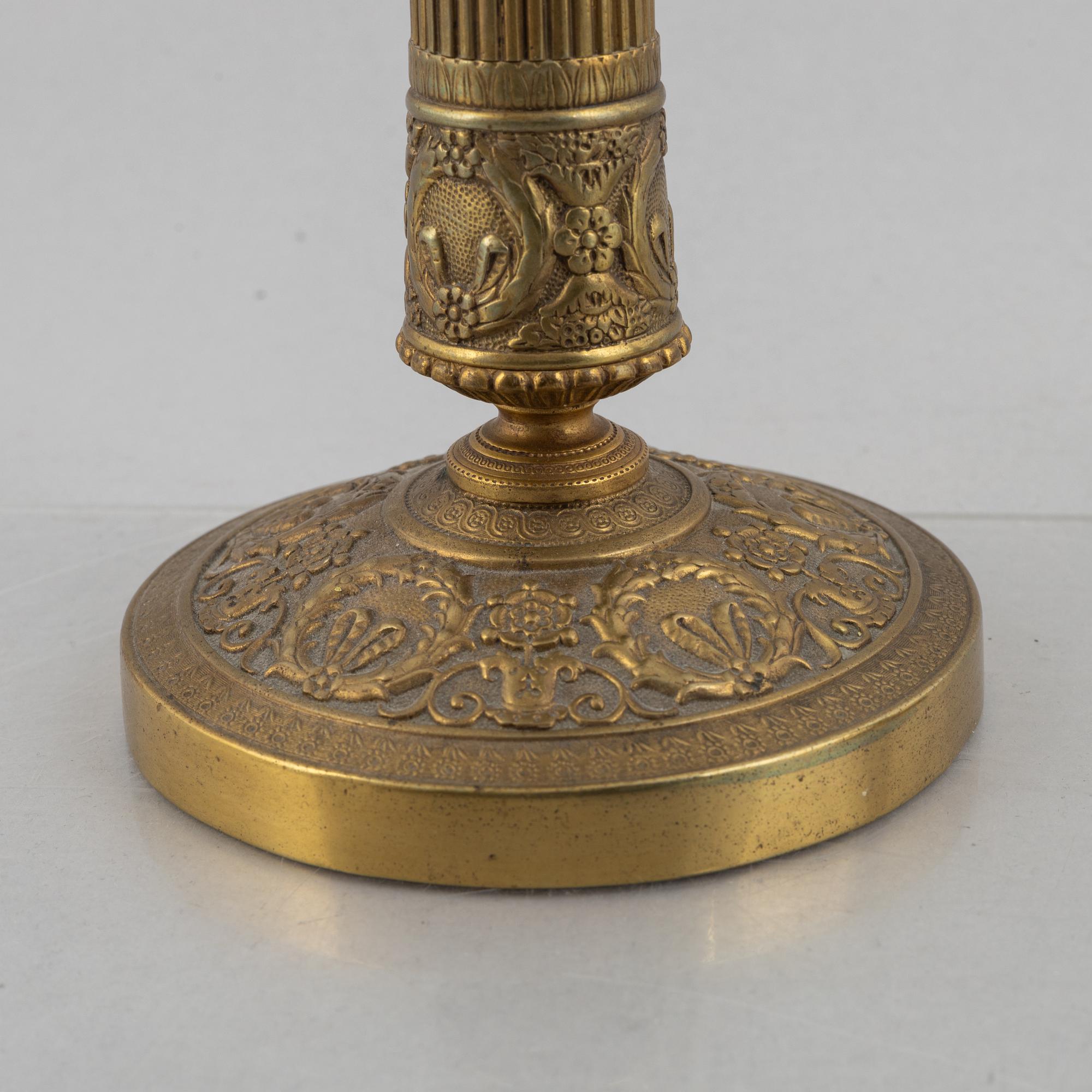A pair of Empire gilt brass candle sticks, first half of the 20th century.