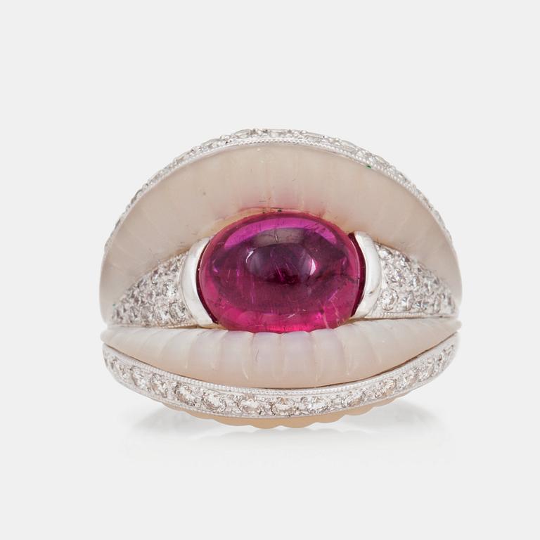 A cabochon cut pink tourmaline, mother of pearl and diamond ring.