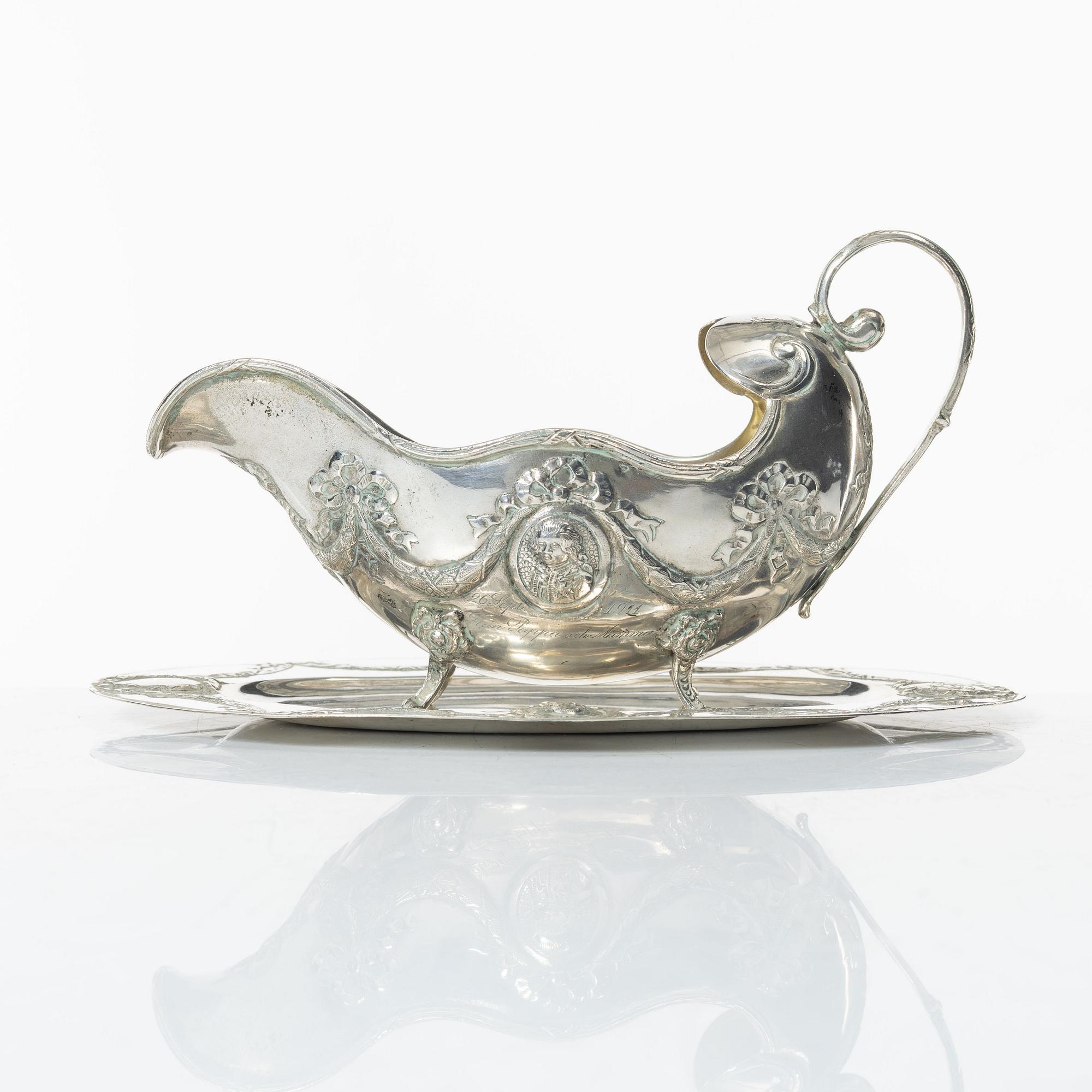 A Rococo style silver sauce boat with dish, 20th Century.