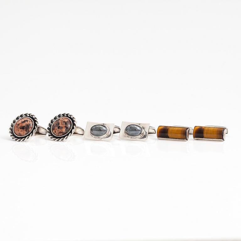 A set of three pairs of silver cufflinks with hematite, tigers eye and granite. Turun Hopea and Osvald Mättö.