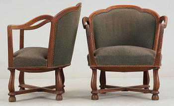 A pair of Ragnar Östman oak easy chairs, Sweden 1920's.