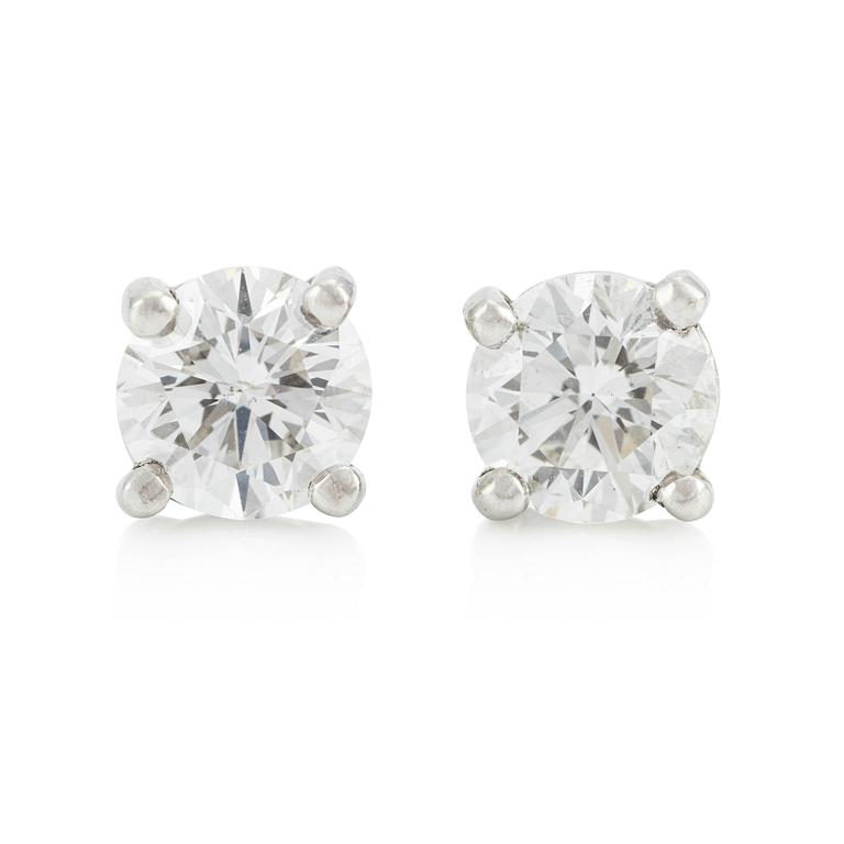 A pair of platinum earrings with round brilliant-cut diamonds.
