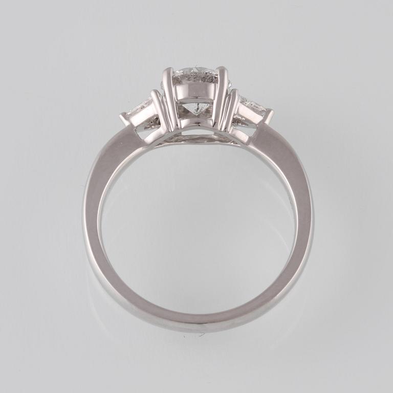 RING, 18K vitguld med briljantslipad diamant 1.03 ct samt 2 triangelslipade diamanter 0.17 ct. Vikt 4,4 gram.