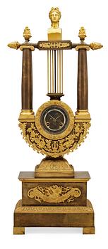 703. A French Empire early 19th century patinated and gilt bronze mantel clock.