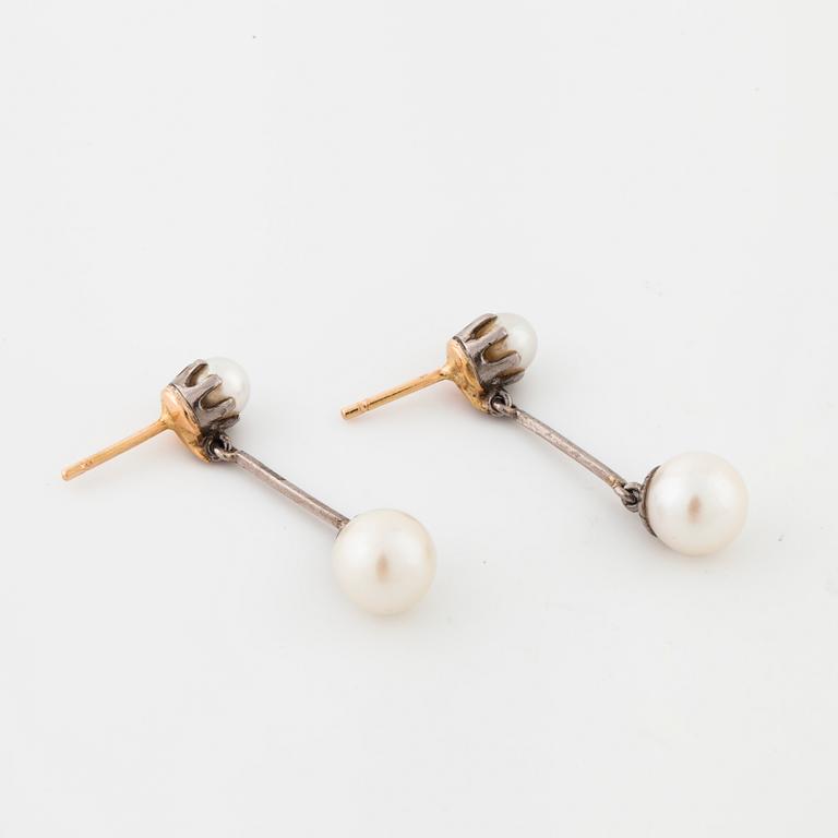 A pair of cultured pearl earrings.