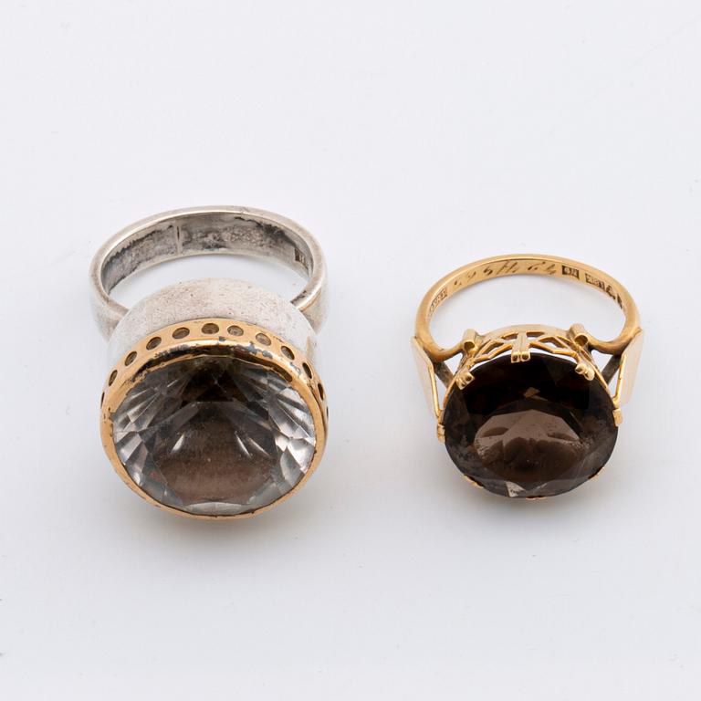 2 RINGS, 18K gold w smoky quartz approx 14 mm, silver and gold w rock crystal approx 16 mm, Stockholm 1963.