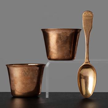 101. A pair of 18th century gilt brass beakers by Caspar Liendenberg, Stockholm  and a spoon by Paul Zachun, Norrköping.