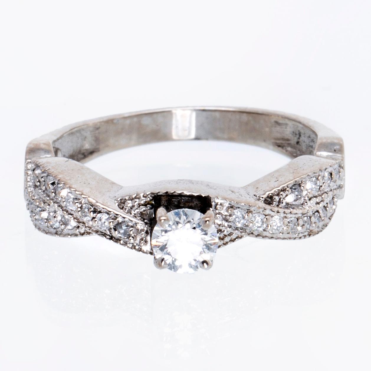 Ring 18K vitguld med 1 briljant ca 0,30 ct och briljanter ca 0,15 ct totalt.