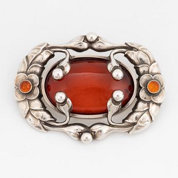 A Georg Jensen brooch 169 silver set with amber.