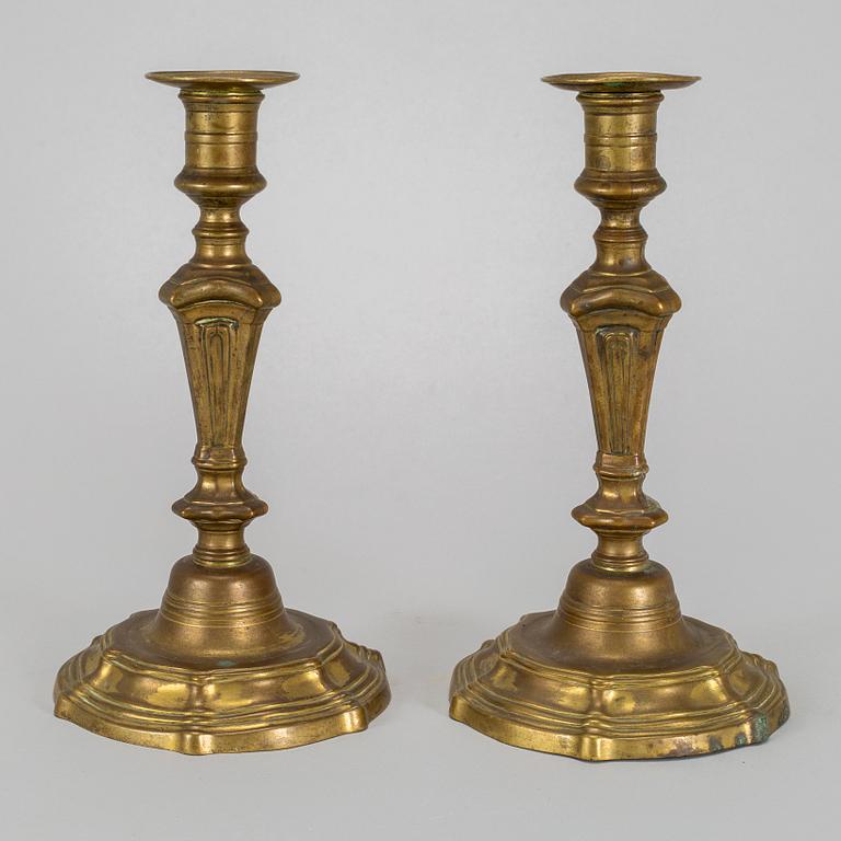 A pair of 18th century bronze candlesticks.