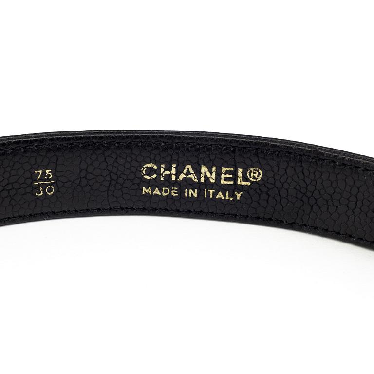 A black leather belt by Chanel.