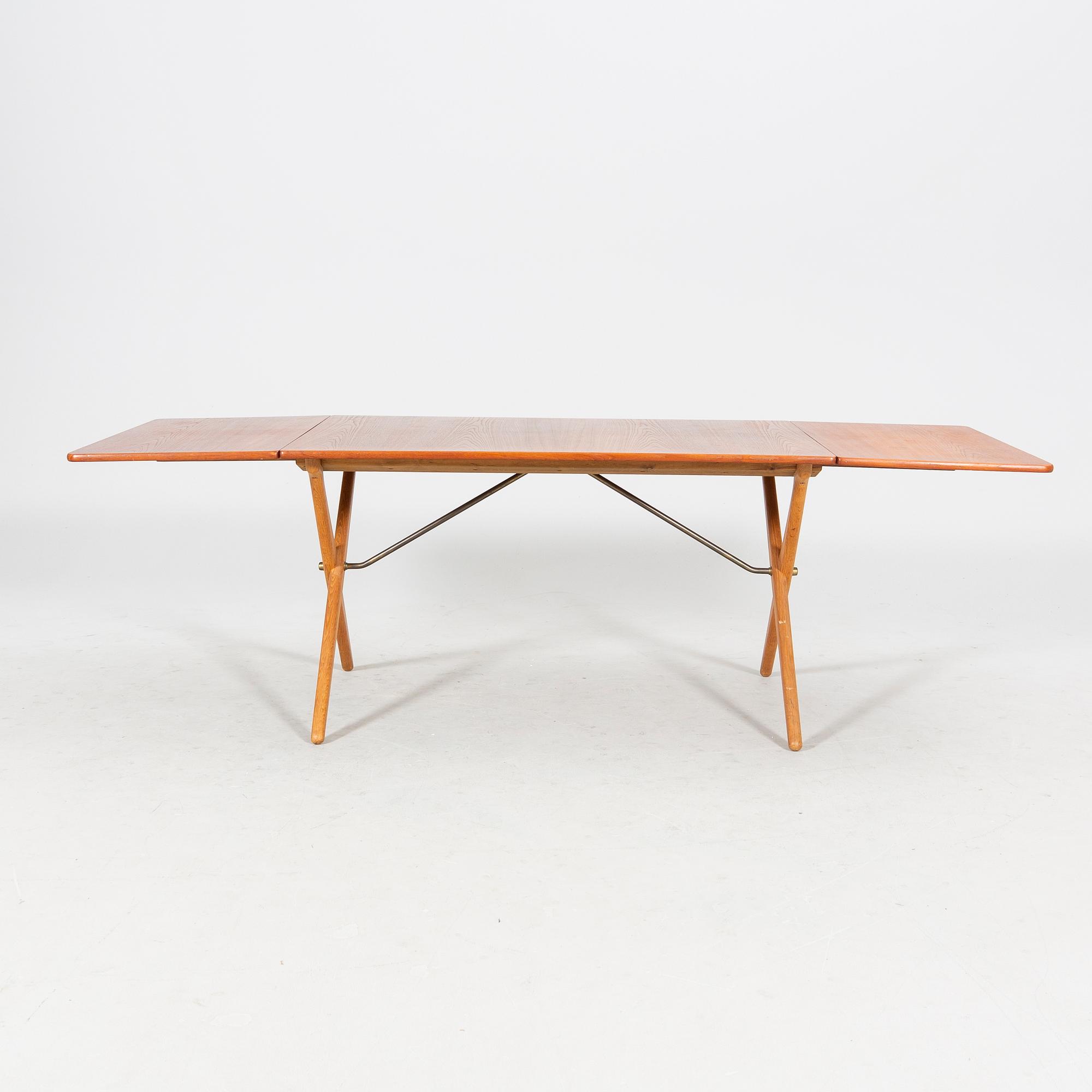A Hans J Wegner "Savbukkebordet AT-303", teak and oak drop-leaf dining table, Andreas Tuck, Denmark 1950s-1960s.