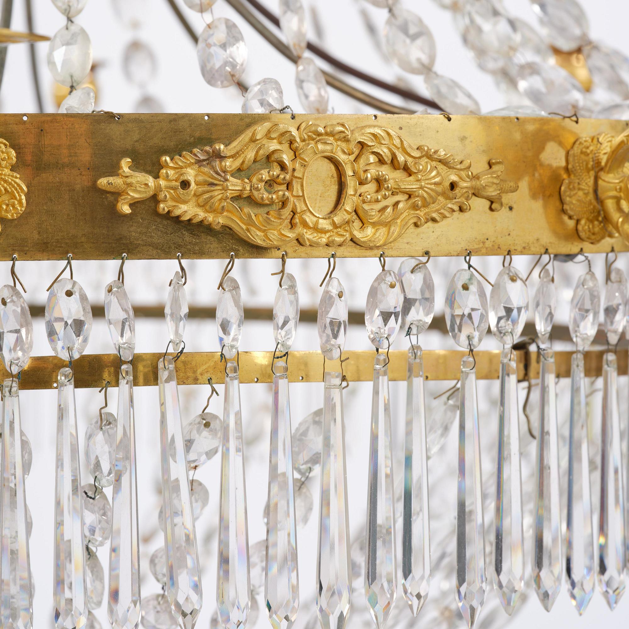 An French Empire eight-light gilt-brass and cut-glass chandelier.