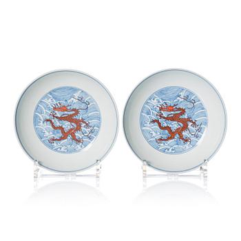 1009. A pair of blue and white and iron red decorated dragon dishes, Qing dynasty with Daoguang mark.
