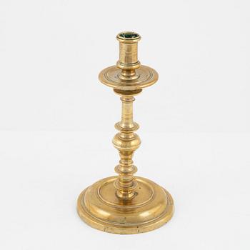 A brass candlestick, 18th century.