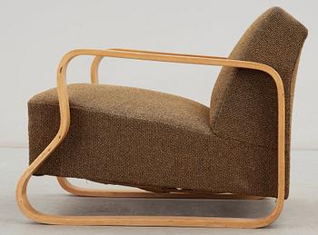 An Alvar Aalto laminated birch 'padded Paimio chair', upholstered in yellow and black fabric.