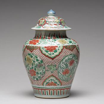 A Transitional wucai baluster vase with cover, 17th Century.