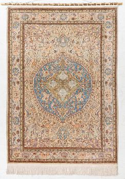 An oriental, silk rug, signed, c. 175 x 125 cm.