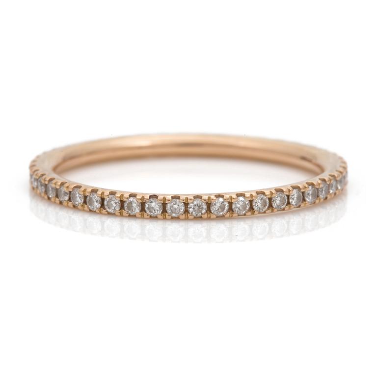 An eternity ring by Georg Jensen set with round, brilliant-cut diamonds.