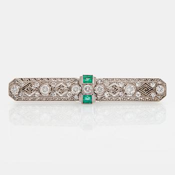 1003. An 18K white gold brooch set with old- and eight-cut diamonds and faceted emeralds.