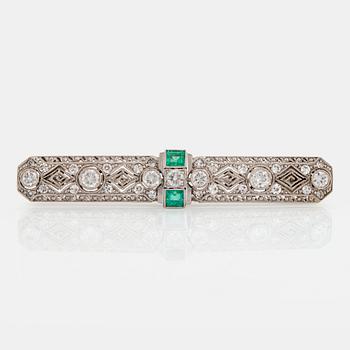 1003. An 18K white gold brooch set with old- and eight-cut diamonds and faceted emeralds.