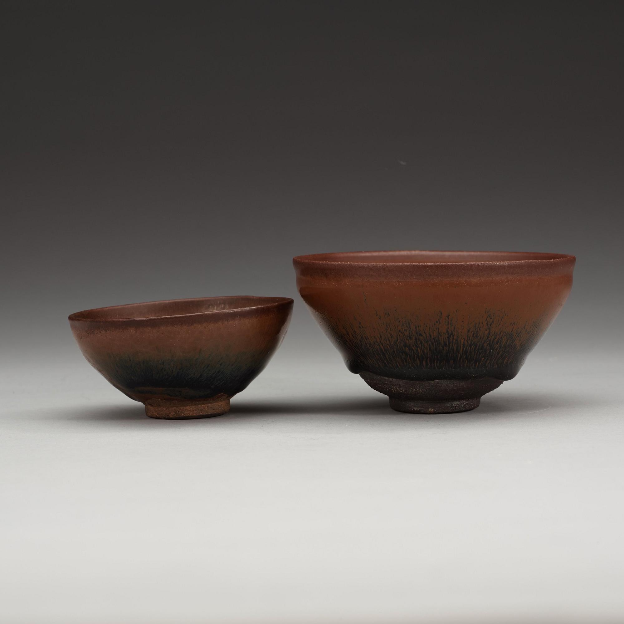 Two temmoku tea bowls, with 'hare's fur' glaze, the glaze pooling short of the unglazed feet. Song dynasty (960-1279).