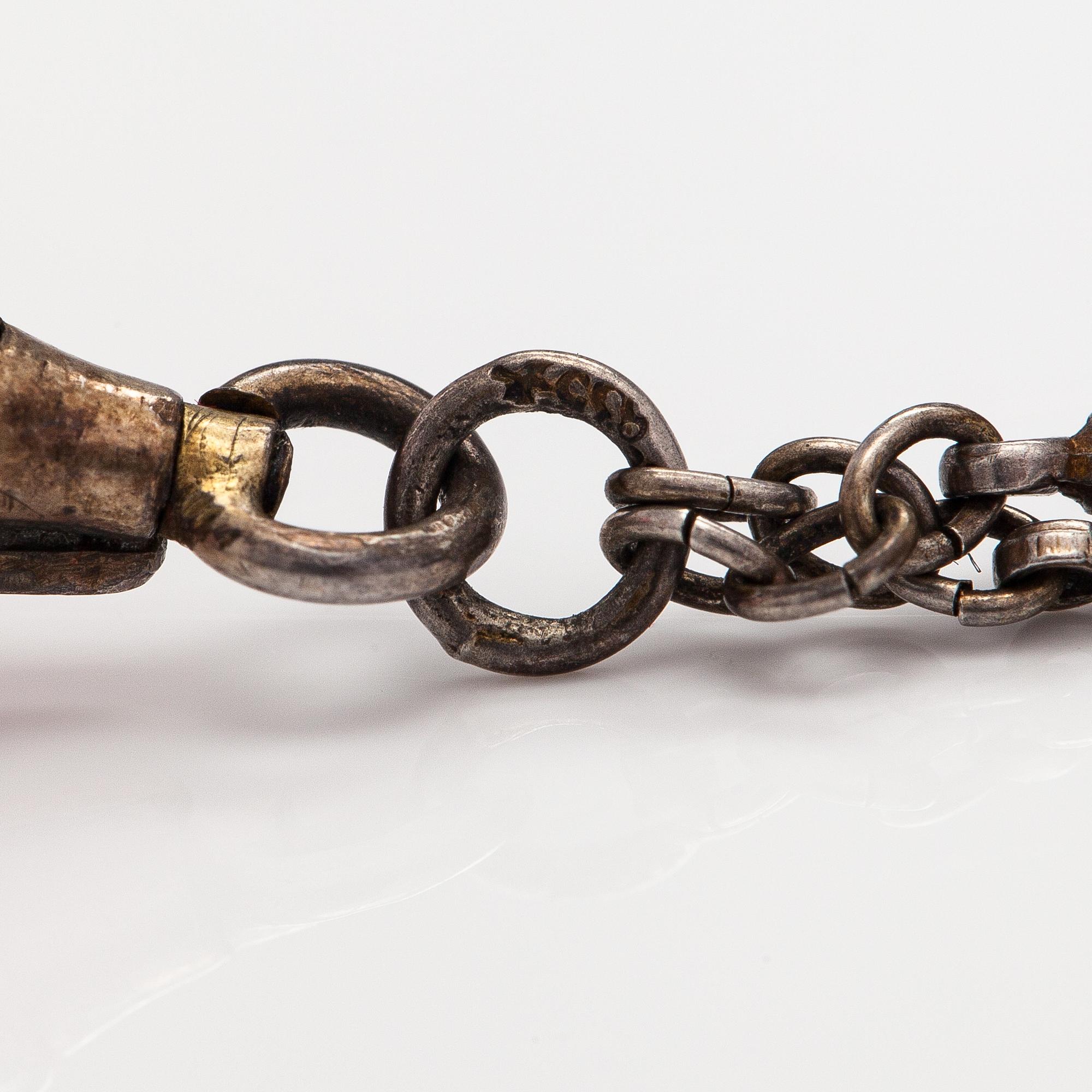 Halsband med klocka, silver och emalj. Tidigt 1900-tal.