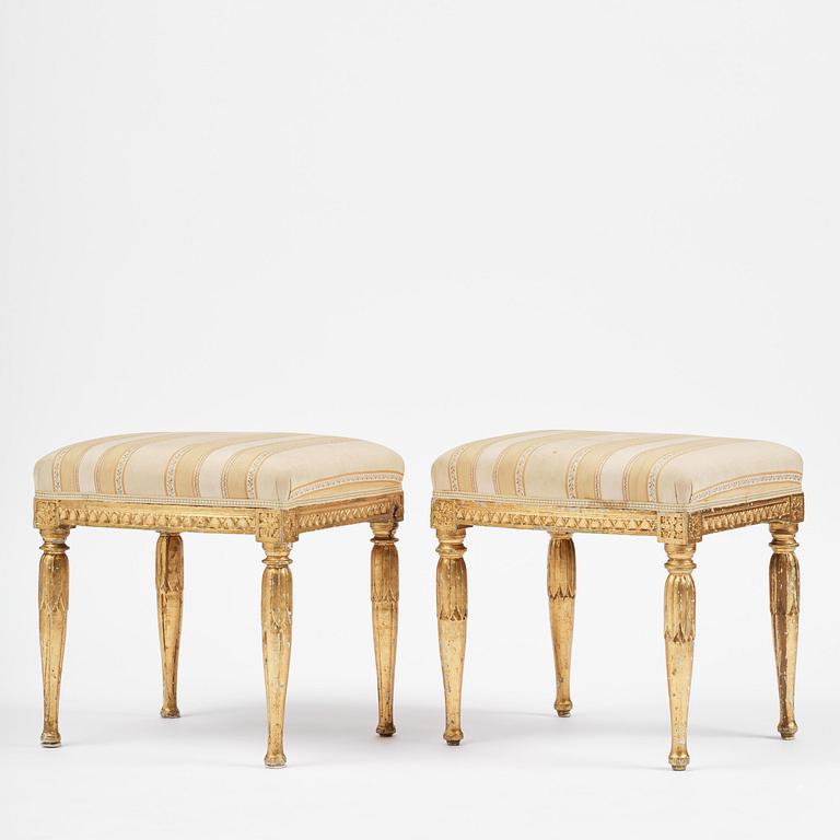 A near pair of late Gustavian giltwood stools, one by J. Hammarström (master in Stockholm 1794-1812).