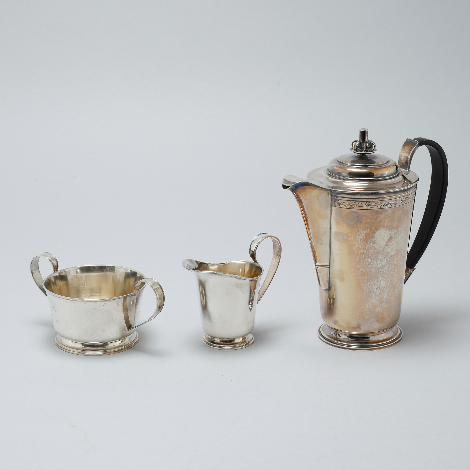 A silver coffee pot, sugar bowl and creamer by Thore Eldh for K&EC in Göteborg, 1949.