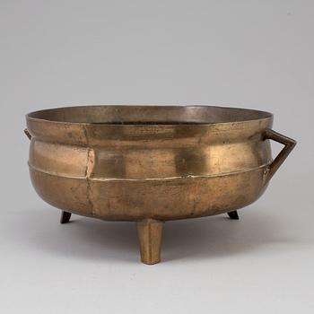 A 19th century brass cauldron.