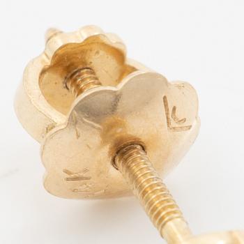 A pair of 14K gold earrings with round brilliant-cut diamonds.