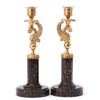 A pair of late Gustavian early 19th century porphyry and ormolu candlesticks.